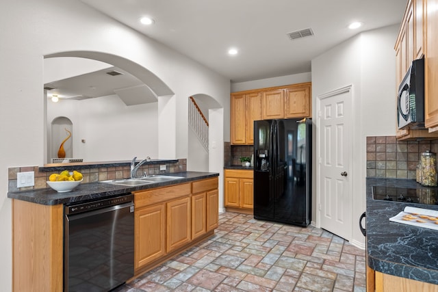 kitchen with kitchen peninsula, black appliances, decorative backsplash, and sink