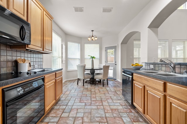 kitchen with sink, decorative light fixtures, backsplash, a chandelier, and black appliances