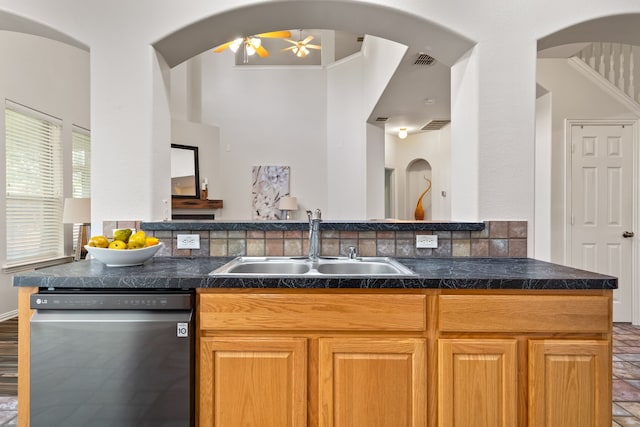 kitchen featuring ceiling fan, ornamental molding, sink, tasteful backsplash, and stainless steel dishwasher