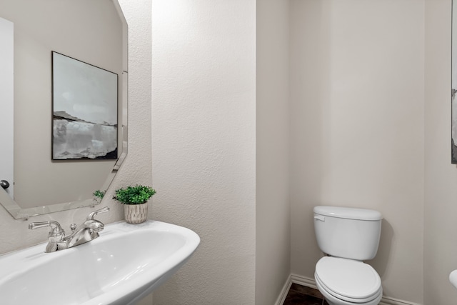 bathroom featuring sink and toilet