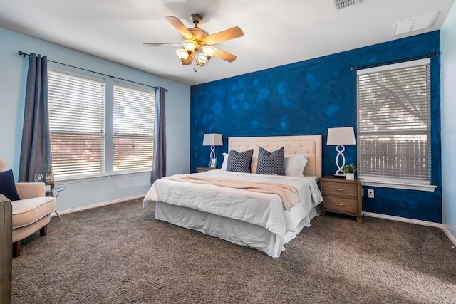 bedroom with dark colored carpet and ceiling fan