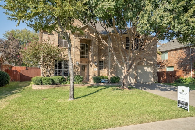 view of front of property featuring a front lawn and a garage