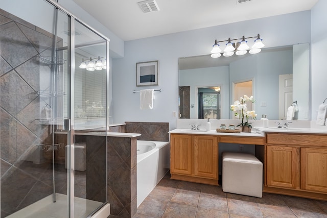 bathroom featuring tile patterned flooring, vanity, and plus walk in shower