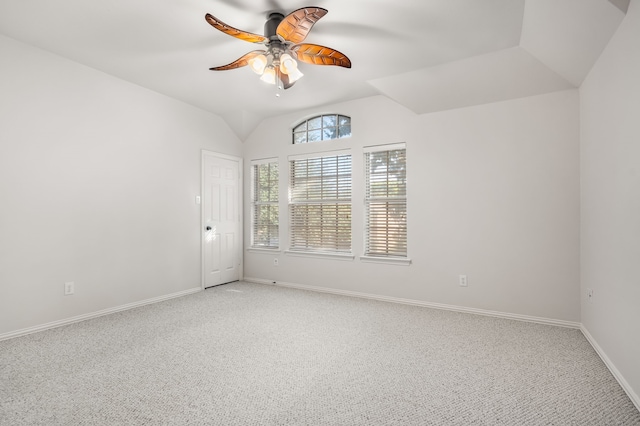 carpeted empty room featuring lofted ceiling and ceiling fan