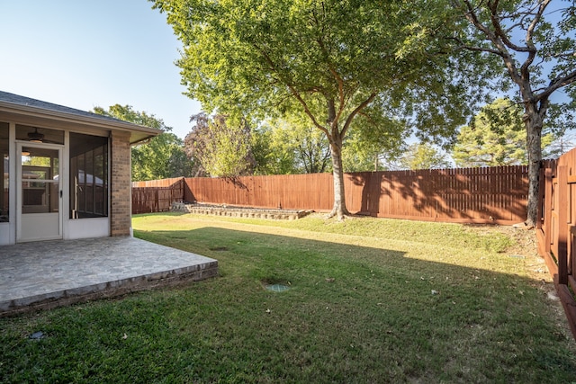 view of yard featuring a sunroom and a patio