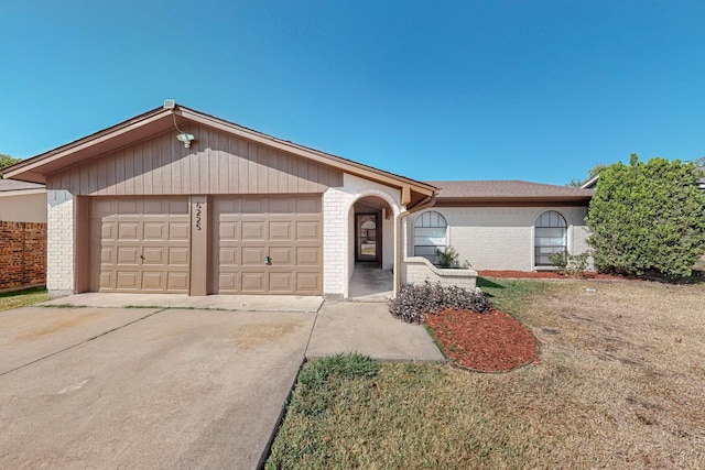 ranch-style house featuring a garage and a front lawn