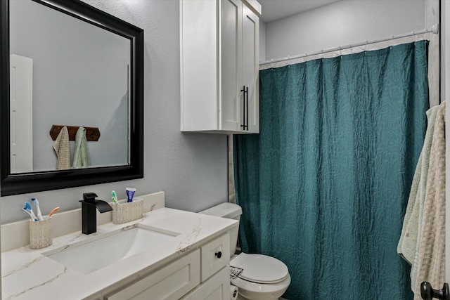 bathroom with toilet and vanity