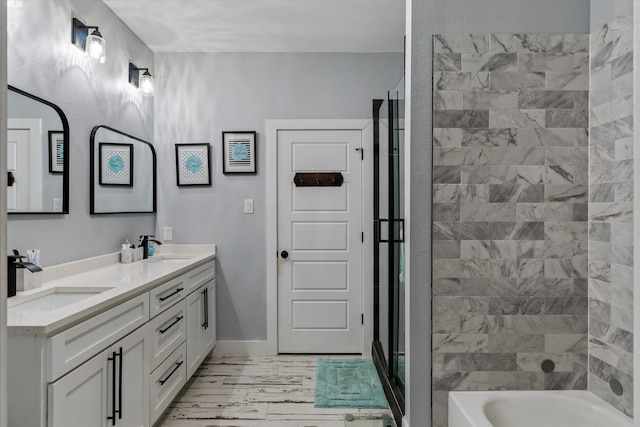 bathroom featuring vanity and independent shower and bath