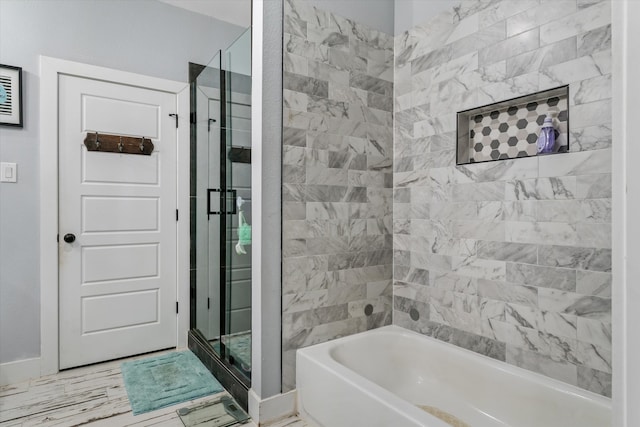 bathroom featuring separate shower and tub