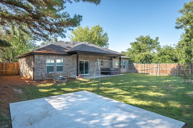 back of house with a patio area and a yard