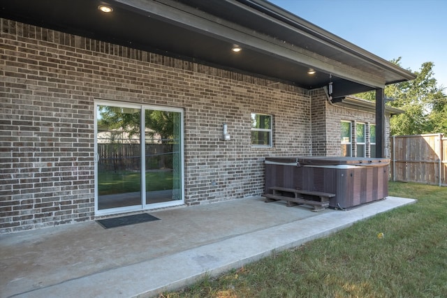 view of patio / terrace featuring central air condition unit and a hot tub