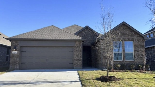 view of front of house with a garage and a front yard