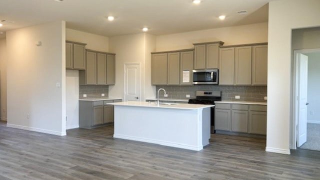 kitchen featuring a kitchen island with sink, sink, gray cabinetry, and appliances with stainless steel finishes