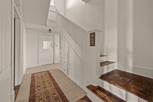 entryway with stairs and light tile patterned floors