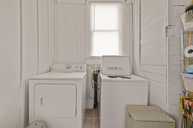 laundry room with washing machine and dryer, laundry area, and tile patterned floors