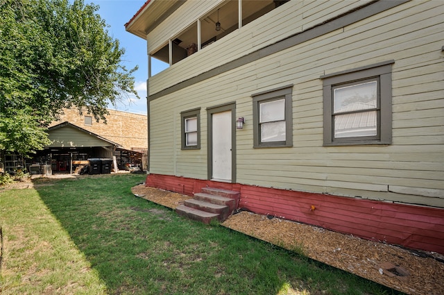 property entrance featuring a lawn