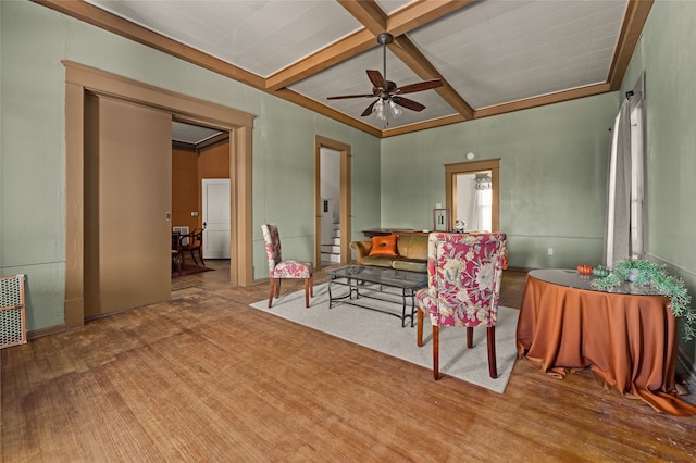 living room with beamed ceiling, ceiling fan, and coffered ceiling