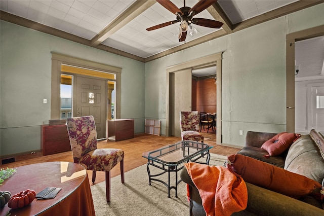 living room with baseboards, a ceiling fan, wood finished floors, and beamed ceiling