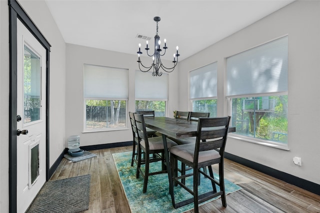 dining room featuring a wealth of natural light, an inviting chandelier, and hardwood / wood-style floors