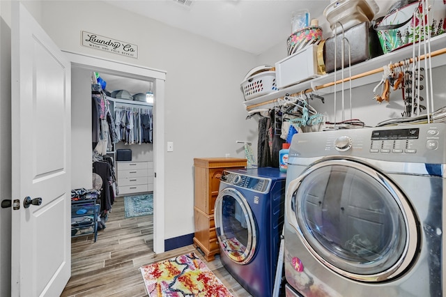 laundry area featuring independent washer and dryer and hardwood / wood-style flooring