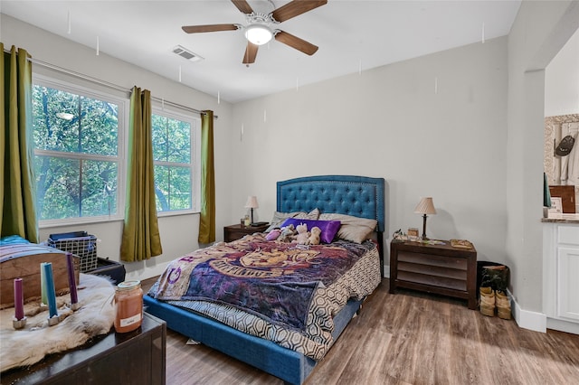 bedroom with hardwood / wood-style floors and ceiling fan