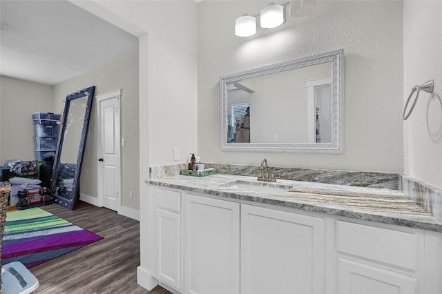 bathroom with vanity and wood-type flooring