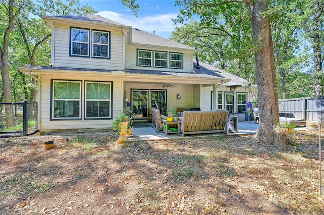 back of property with a patio, an outdoor living space, and ceiling fan