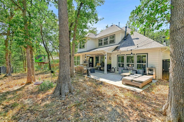 back of property featuring an outdoor hangout area and a patio area