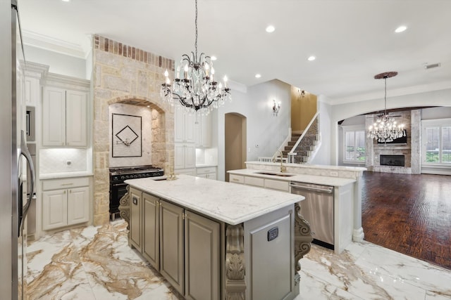 kitchen with decorative backsplash, a kitchen island, stainless steel appliances, and a fireplace