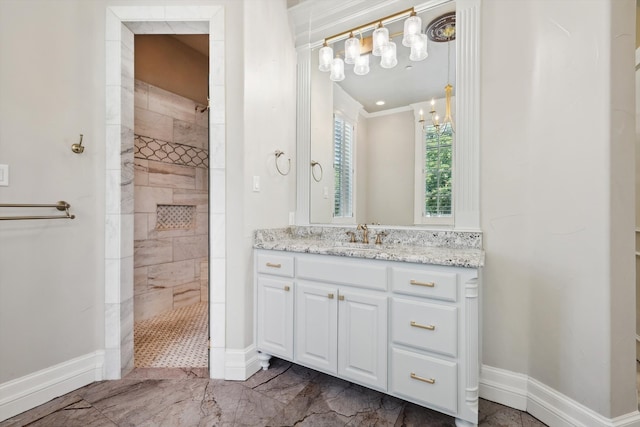 bathroom featuring a chandelier, a tile shower, and vanity