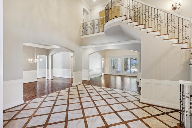 entryway with a high ceiling and an inviting chandelier