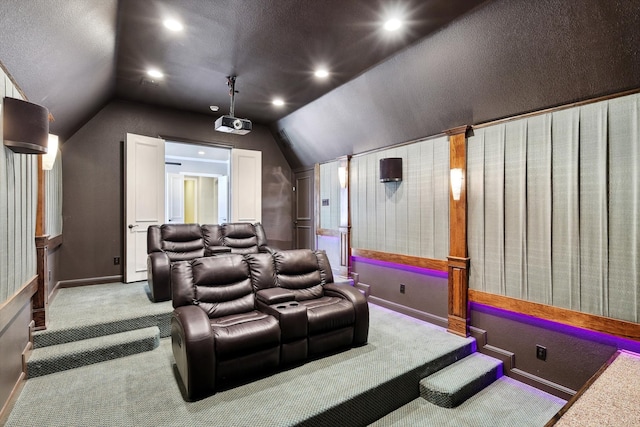 cinema room with light carpet and lofted ceiling