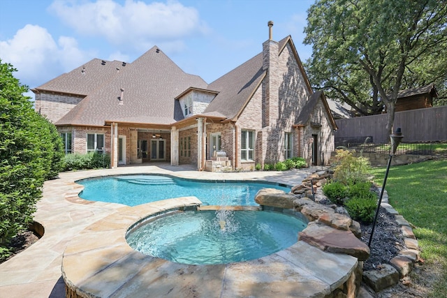 view of swimming pool featuring an in ground hot tub, ceiling fan, and a patio area