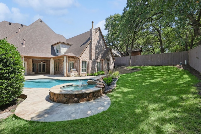 view of pool featuring a patio area, a yard, and an in ground hot tub