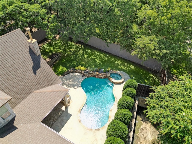 view of swimming pool with an in ground hot tub, a patio area, and a lawn