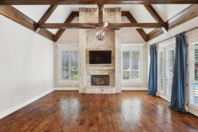 unfurnished living room with ceiling fan, a stone fireplace, wood-type flooring, and high vaulted ceiling