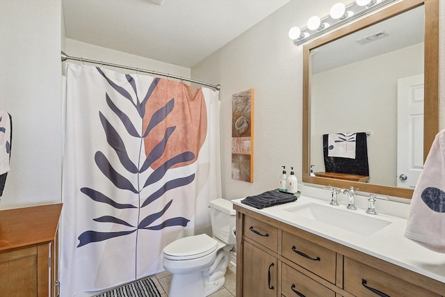 bathroom with tile patterned flooring, curtained shower, vanity, and toilet