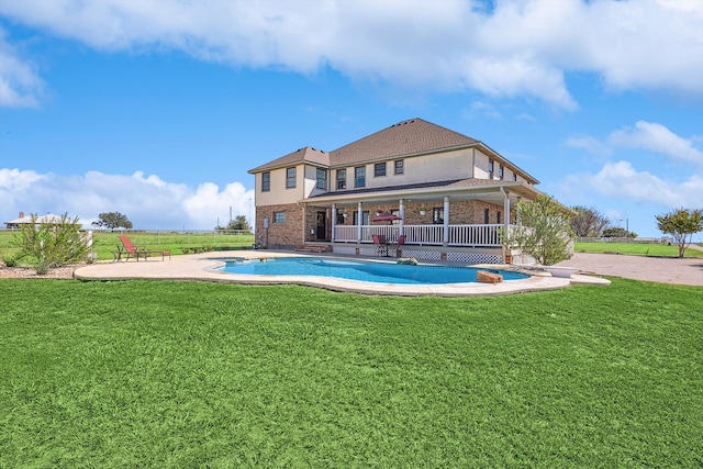 rear view of house with a lawn and a patio