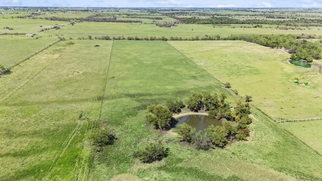 drone / aerial view with a water view and a rural view