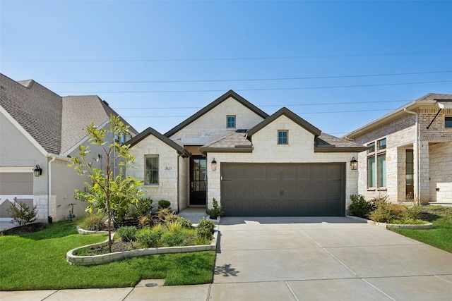 view of front of house featuring a front yard and a garage