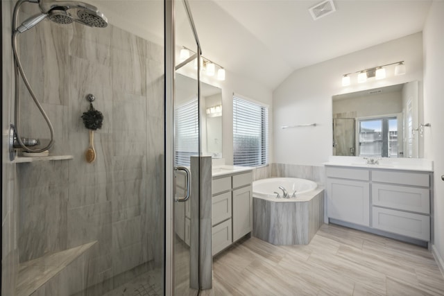 bathroom featuring lofted ceiling, plus walk in shower, vanity, and a healthy amount of sunlight