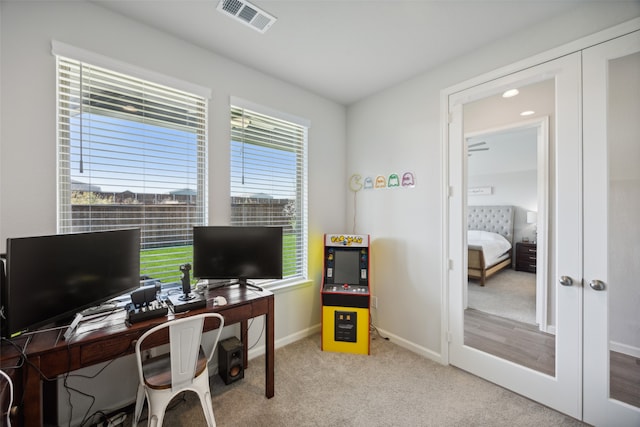 carpeted office with french doors