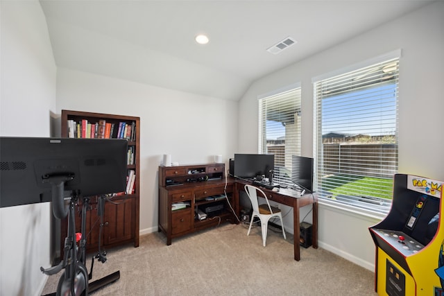 office area featuring light carpet and lofted ceiling