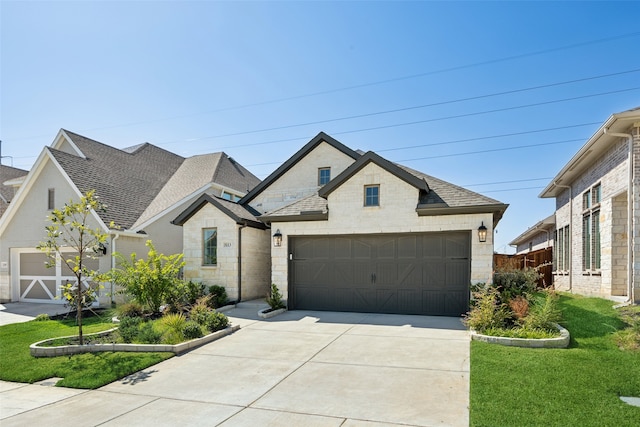 view of front of property with a front yard and a garage