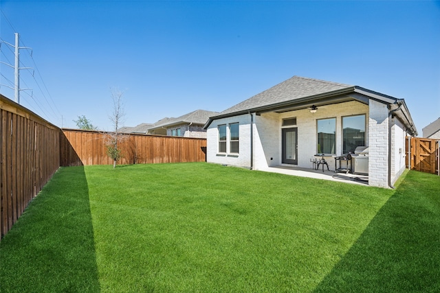 rear view of house with a yard and a patio area