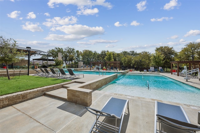 view of pool with a lawn and a patio area