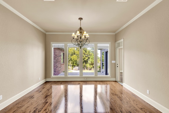 unfurnished dining area featuring ornamental molding, a chandelier, and hardwood / wood-style flooring