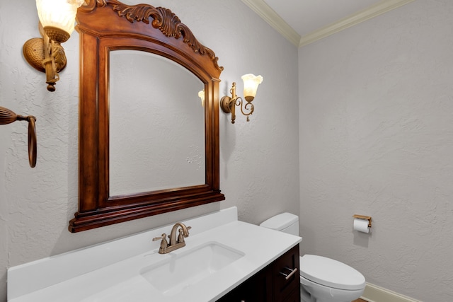 bathroom featuring crown molding, vanity, and toilet