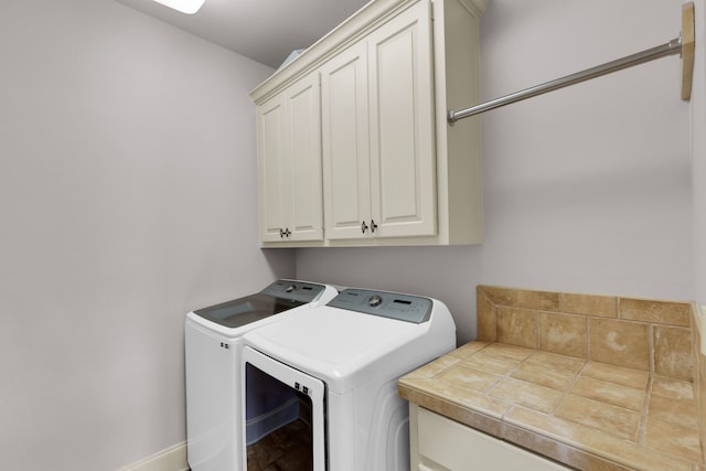 laundry room with cabinets and separate washer and dryer