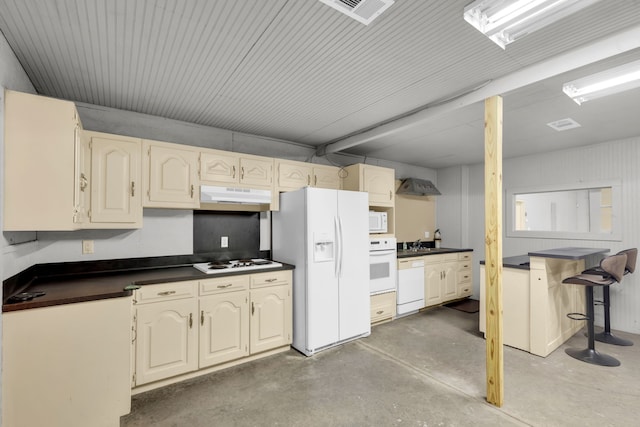 kitchen featuring a kitchen breakfast bar, white appliances, and sink